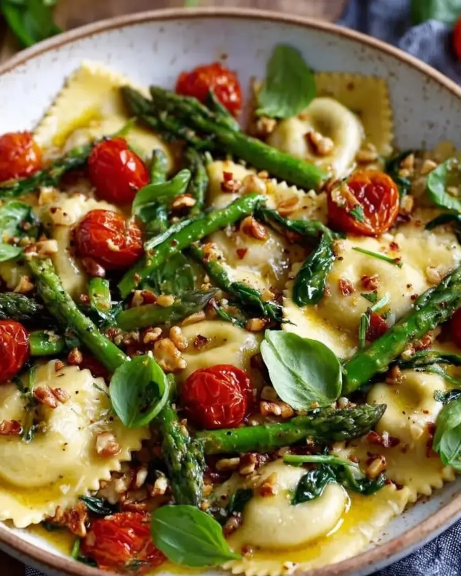 Fresh Asparagus and Tomato Ravioli Toss plated beautifully with steam rising.